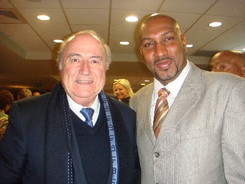 Photo: Sport Minister Anil Roberts (right) poses with FIFA President Sepp Blatter. The Sport Minister's accounting has not met the approval of the Auditor General.