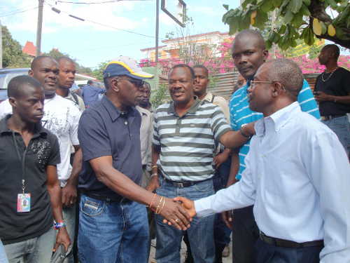Haiti--Warner meets two-day survivor Jean Degraff