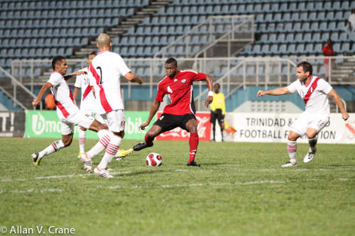 Photo: Trinidad and Tobago defender Sheldon Bateau (centre) made an encouraging debut against Peru. (Courtesy Allan V. Crane/ Wired868)