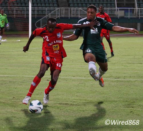 Photo: Caledonia AIA right back Kareem Joseph (left) shoots past ex-W Connection attacker Shahdon Winchester. Joseph is arguably the Pro League's best right back. (Courtesy Wired868)