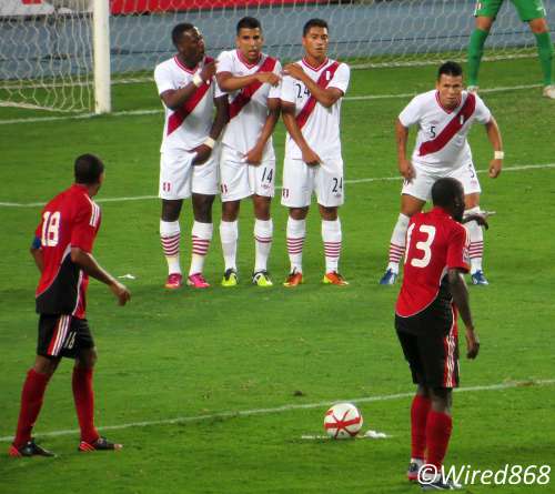 Photo: Trinidad and Tobago attacker Cornell Glen (right) and Densill Theobald line up a free kick against Peru. (Courtesy Juliet Solomon/Wired868)