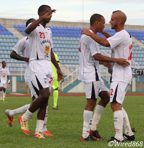 Photo: Caledonia AIA playmaker Densill Theobald is embraced by Argentine teammate Miguel Romeo (right) while Jamal Gay congratulates his fellow scorer. (Courtesy Wired868)