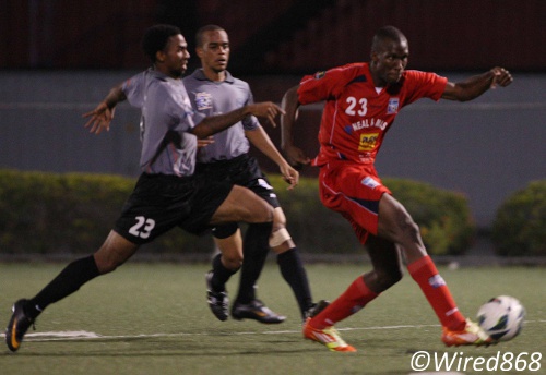 Photo: Caledonia AIA striker Jamal Gay (far right) leaves St Ann's Rangers defenders Kadeem Drayton (far left) and Muhammad Nakhid in his wake to score. (Courtesy Wired868)