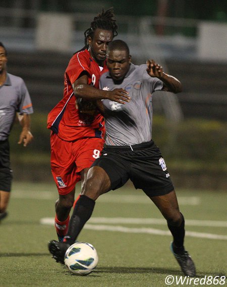 Photo: St Ann's Rangers defender Jamal Jack (right) wrestles the ball from Caledonia AIA attacker Keyon Edwards in a rare moment of defiance. (Courtesy Wired868)