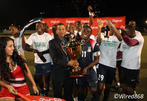 Photo: Pro League CEO Dexter Skeene hands the league trophy over to stand-in Defence Force captain Kevon Carter. (Courtesy Wired868)