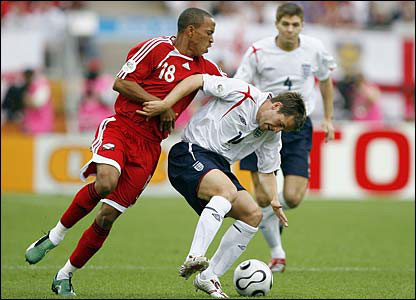 Photo: Trinidad and Tobago midfielder Densill Theobald (left) harasses England star Michael Owen during the 2006 World Cup.