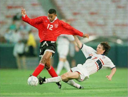 Photo: Ex-T&T midfielder David Nakhid (left) in action against the United States. Nakhid was the first Trinidad and Tobago player to participate in UEFA club competition. But he was denied the chance to represent his country until in his 30's.