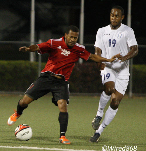 Photo: Ex-Central FC midfielder Hayden Tinto (left) drives at Police player Christon Thomas during the 2012/13 Pro League season. Tinto is one of several Pro League players who have joined the NSL this season. (Courtesy Wired868)