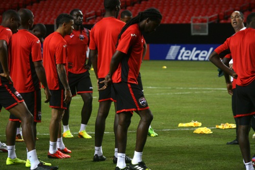 Photo: Trinidad and Tobago midfielder Keon Daniel (third from right) is focused on getting the job done in the 2013 CONCACAF Gold Cup quarterfinals against Mexico. (Courtesy TTFA Media)