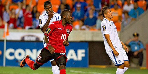 Photo: Kevin Molino (centre) reacts after scoring Trinidad and Tobago's second goal against Honduras last night. (Courtesy CONCACAF)