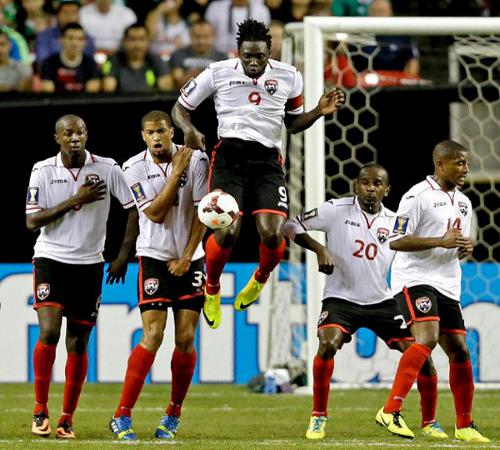 Photo: Trinidad and Tobago players (from left) Daneil Cyrus, Radanfah Abu Bakr, Kenwyne Jones, Seon Power and Andre Boucaud try to keep out a Mexico free kick. (Courtesy YahooSports)