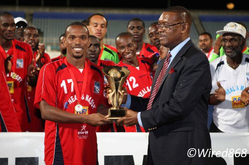 Photo: Caledonia AIA midfielder Akim Armstrong (left) receives his 2013 TTFF FA Trophy MVP award from TTFF president Raymond Tim Kee. (Courtesy Wired868)